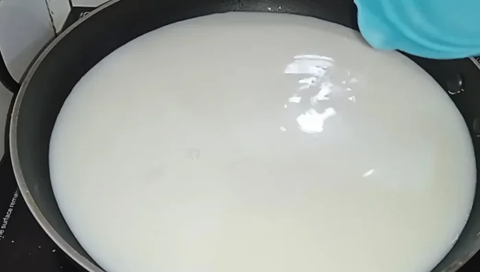 In the same pan, heat milk over medium-high heat until it boils. Then, simmer for about 5 minutes until thickened.