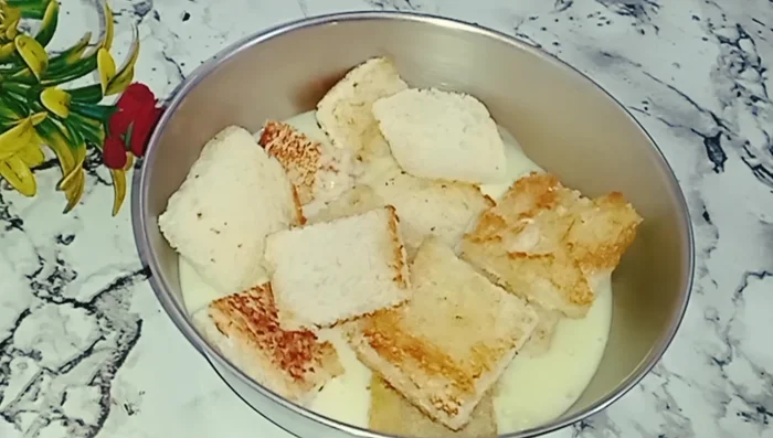 Pour the remaining milk mixture over the bread. Gently mix to combine, ensuring all pieces are coated.