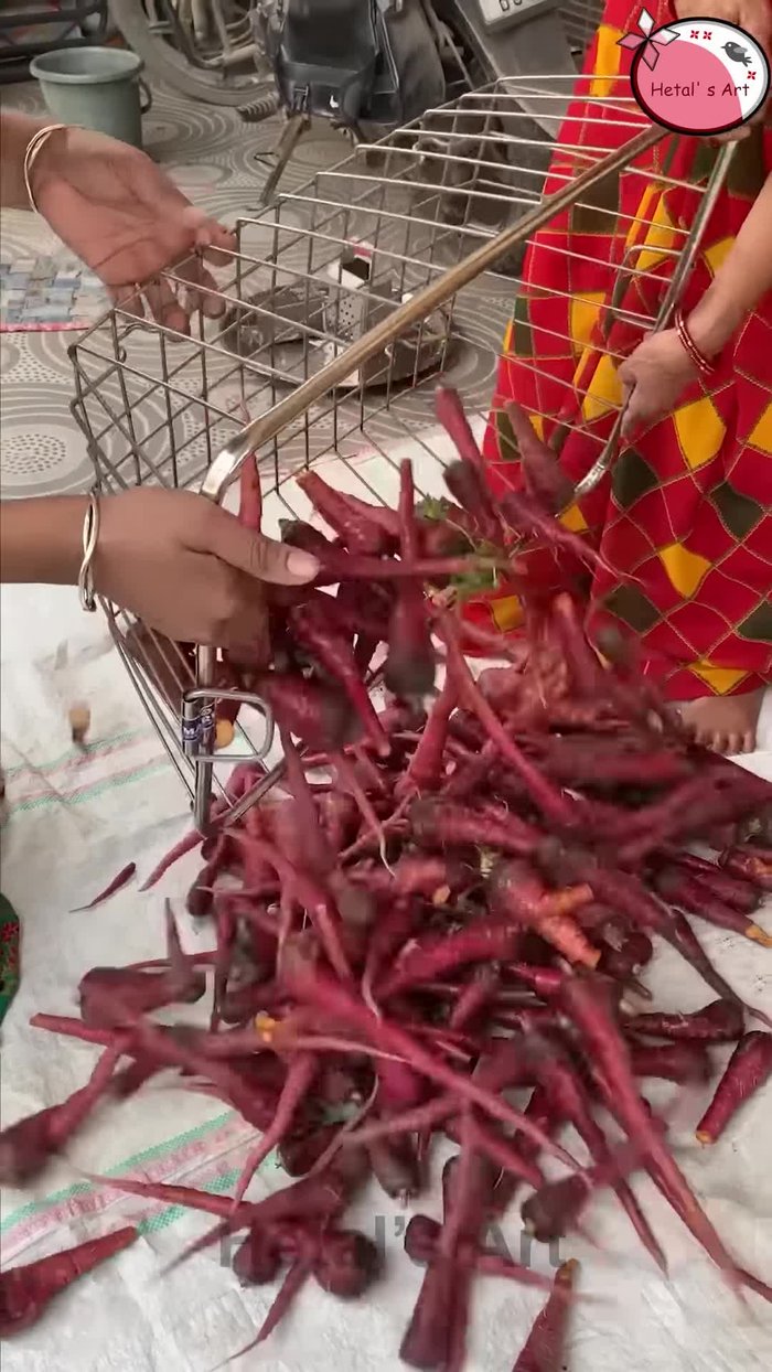 Add the sliced/grated carrots to the pan. Stir well. (Visual and auditory clues from the audio/video.)