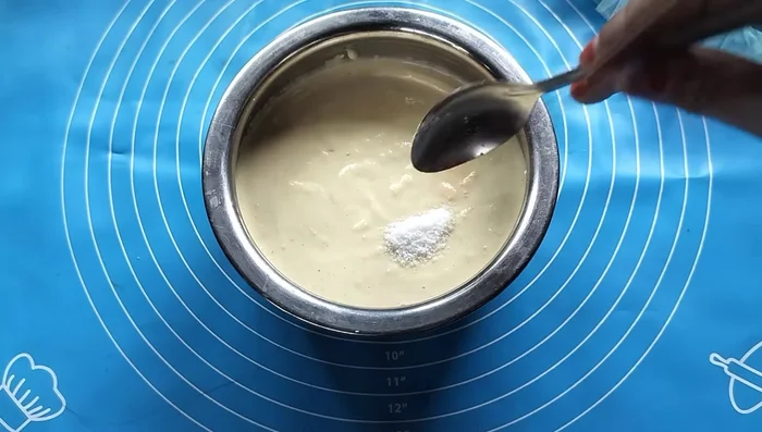 Add salt and food color (or turmeric) to the batter. Mix well. Note: Spices were added later in the video.
