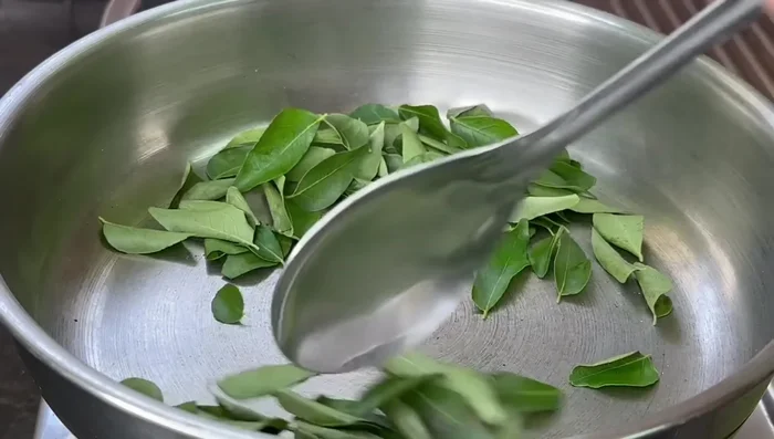 Fry curry leaves until crispy. Set aside to cool.