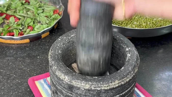 Grind the fried ginger, peppercorns, cumin seeds, chilies, and curry leaves into a fine powder in a mixer.