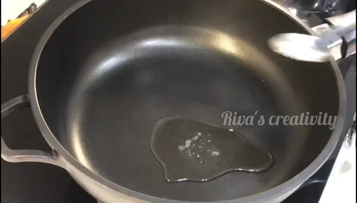 Heat ghee in a pan and fry cashew nuts until golden brown.