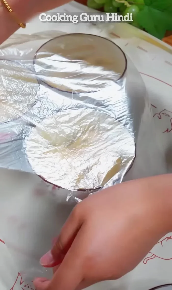 When it has grown considerably in size, brush a layer of egg yolk over it. Cover again with plastic wrap.