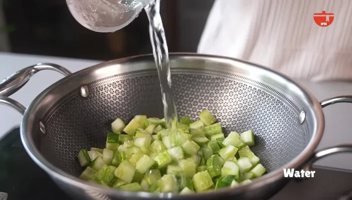 Simmer diced cucumbers in a kadhai with a little water.