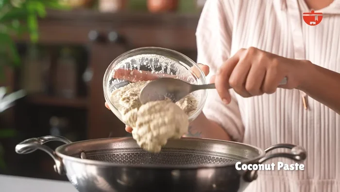 Add the coconut paste to the simmering cucumbers and mix well.
