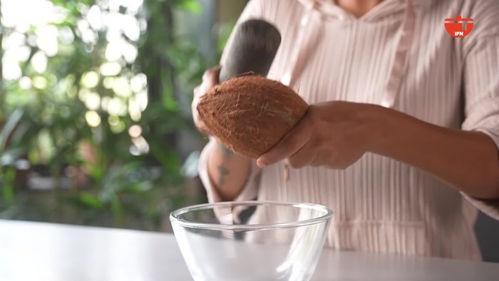 Crack open a fresh coconut and chop it up.