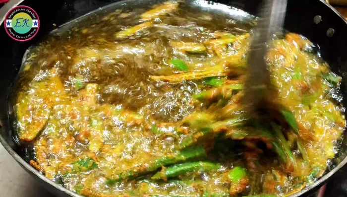 Fry the okra for 1-2 minutes on each side, avoiding flipping too early to prevent spices from falling off.