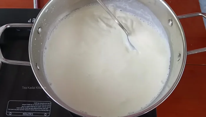 Add the rice balls to the boiling milk, stirring to prevent lumps.