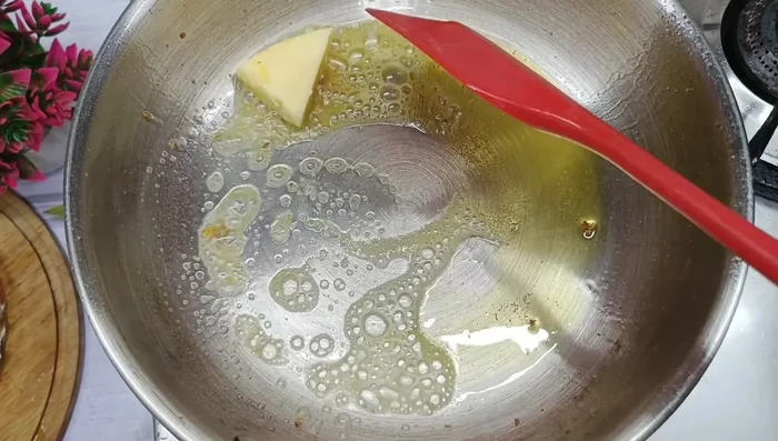 In the same pan, add butter and sauté chopped garlic until fragrant.