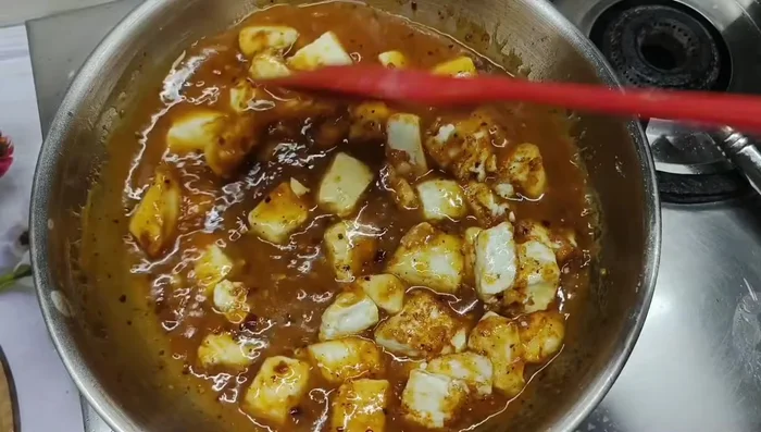 Add the fried paneer to the gravy and let it simmer for a minute or two.