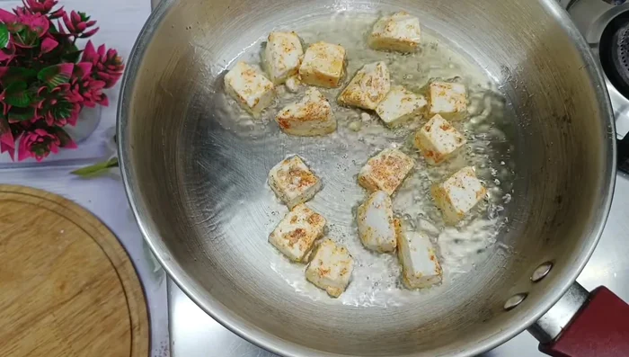 Heat oil in a pan. Fry the paneer until golden brown on both sides. Set aside.