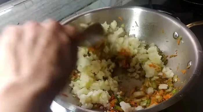 Mash a boiled potato and add it to the pan. (Alternatively, use raw banana or sweet potato). Mix well and fry on high flame, then lower the flame.
