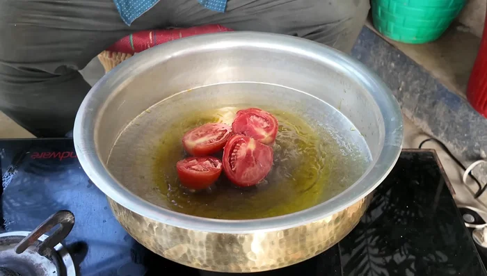 Add tomatoes and cook for about 5 minutes on high flame. Remove the peels.
