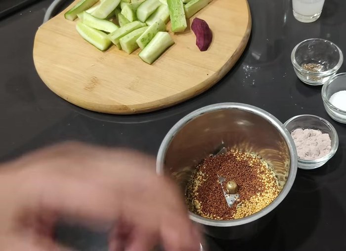In a blender, coarsely grind the fennel seeds, mustard seeds (both types), crushed black peppercorns, and beetroot slices.