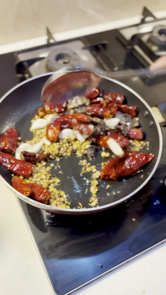 Remove the mixture from the pan, let it cool, and then transfer it to a mixer jar.