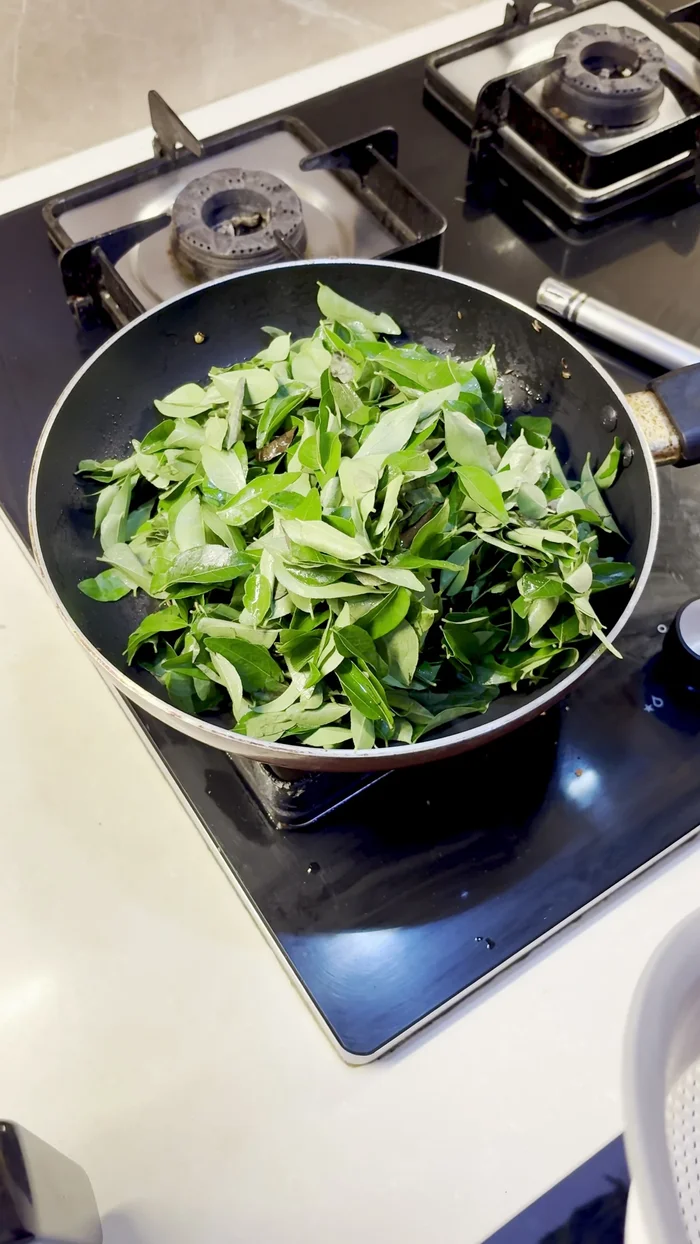In the same pan, add curry leaves and roast them briefly.