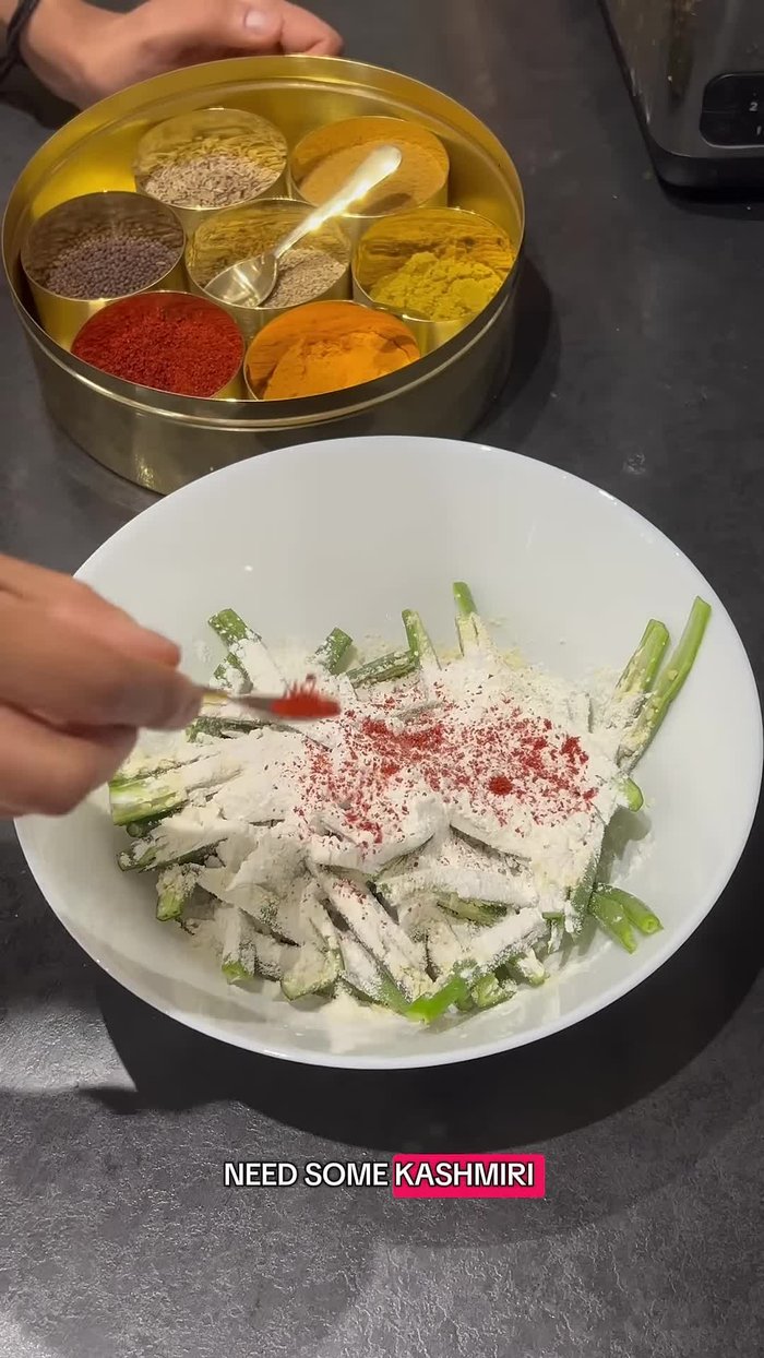 Add Kashmir red chili powder, turmeric powder, coriander powder, cumin powder, amchur, garam masala, and salt. Mix well with your hands.