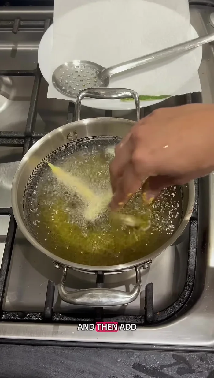 Heat oil in a pan over medium heat.