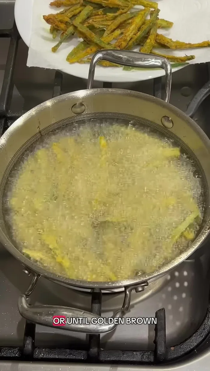Carefully add the okra mixture to the hot oil and fry until golden brown (watch closely to prevent burning).