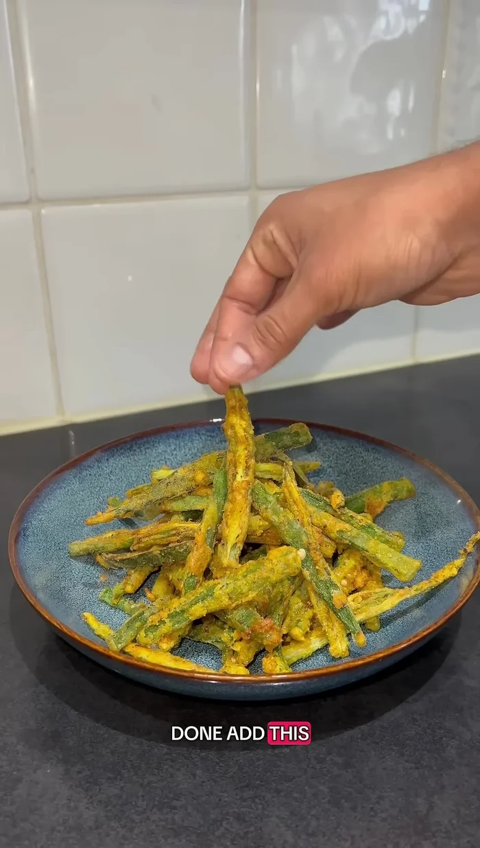 Remove the fried okra and place it in a serving bowl.