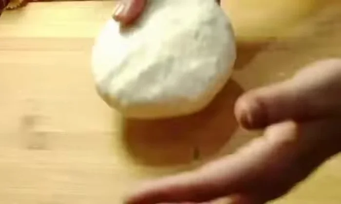 Roll out the dough balls gently, dusting with flour to prevent sticking.
