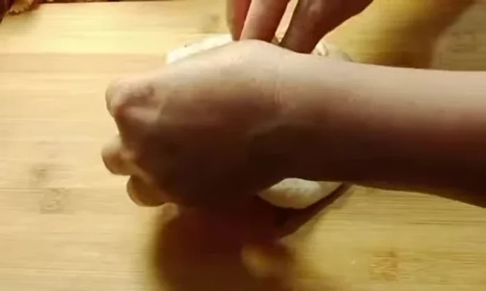 Add cheese stuffing to each dough ball, ensuring not to overload.