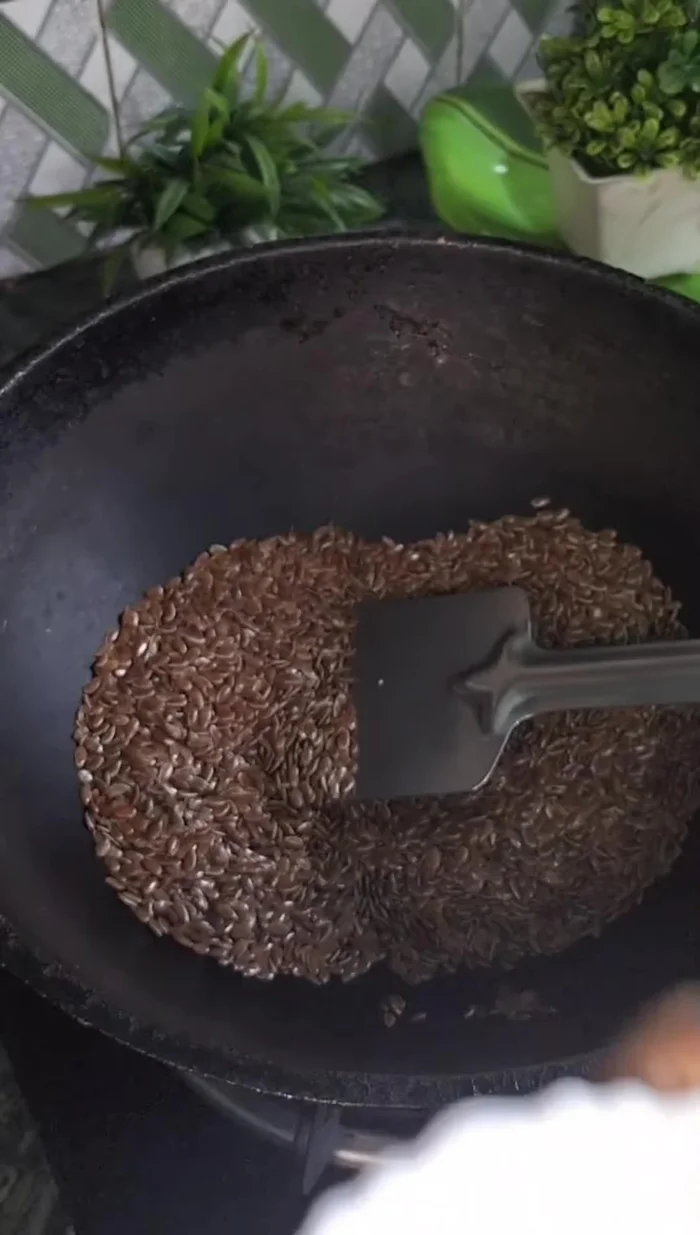 Roast flax seeds in a pan until they start crackling.