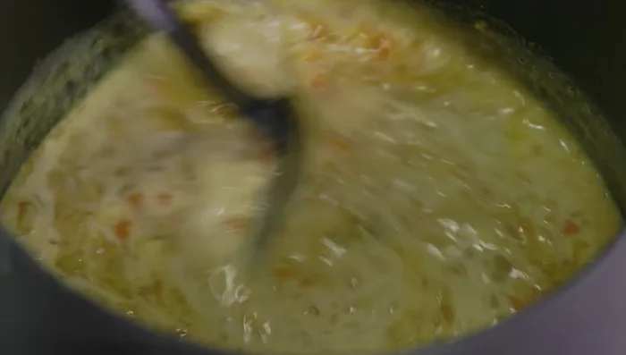 Stir in coconut milk and reheat gently.