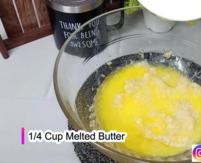 In a bowl, combine mashed bananas, melted butter, powdered sugar (both granulated and brown), curd, and vanilla essence. Mix well until smooth.
