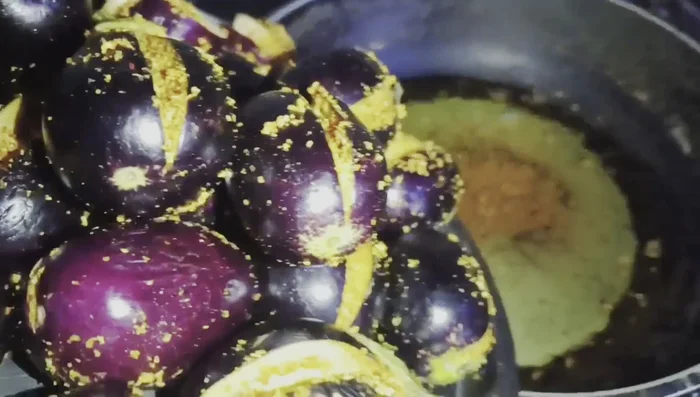 Fry the stuffed brinjal: Gently place the stuffed brinjals in the hot oil and fry until golden brown. Stir occasionally.