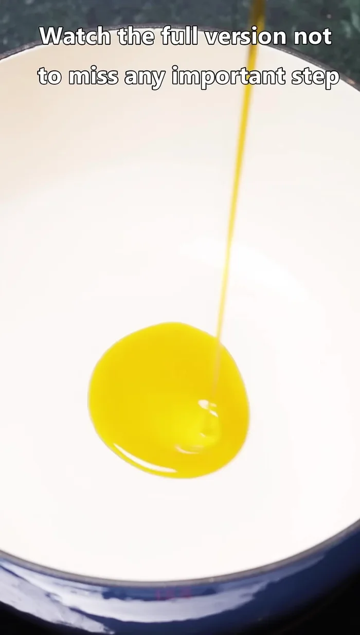 Heat mustard oil in a pan and partially fry the chicken until lightly browned. Remove and set aside.
