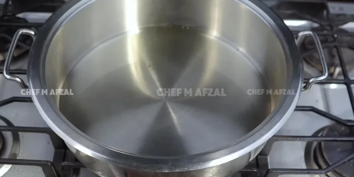Make the pulao base: Heat oil in a pot, add tomatoes, ginger-garlic paste, and green chili paste. Fry for 2-3 minutes until tomatoes soften.