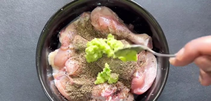 Add black pepper powder, ginger-garlic paste, and curd to the marinated chicken. Mix well.