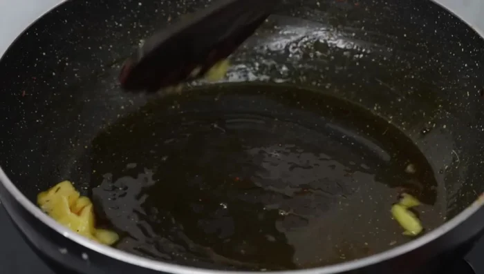 In the same kadai, heat 1 tbsp of ghee or oil. Add 1 finely chopped small onion and sauté until softened.