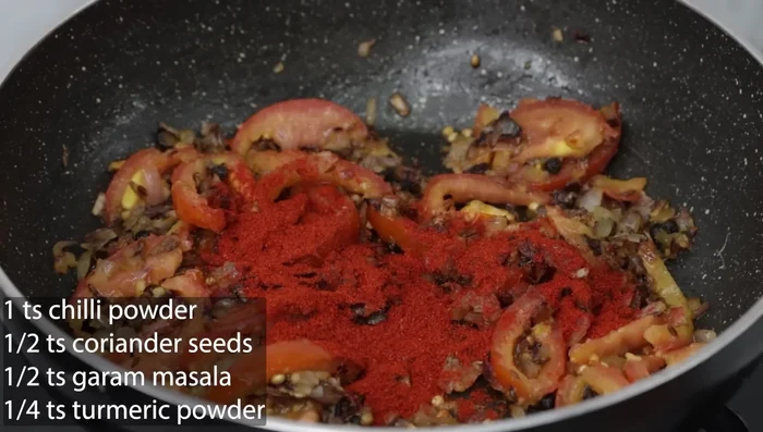 Add 1 tsp chili powder, 1/2 tsp coriander powder, 1/4 tsp turmeric powder, and 1/2 tsp garam masala. Mix well.