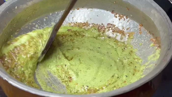 Add the ground masala paste and fry until the raw smell disappears.