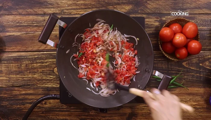 Add chopped tomatoes, salt, and turmeric powder. Cook for 5 minutes until tomatoes are soft and mushy.