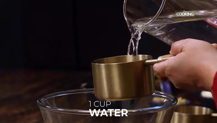 Whisk together gram flour and 1 cup of water until smooth. Add 2 more cups of water and mix thoroughly. Set aside.