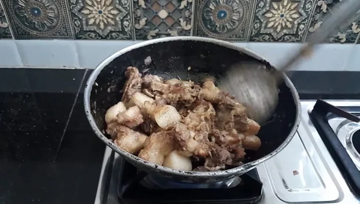 Add tomatoes and press them down into the meat to help them cook quickly.