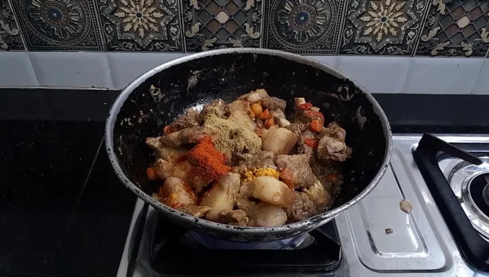 Add turmeric, chili, and coriander powder. Mix well to combine all spices.