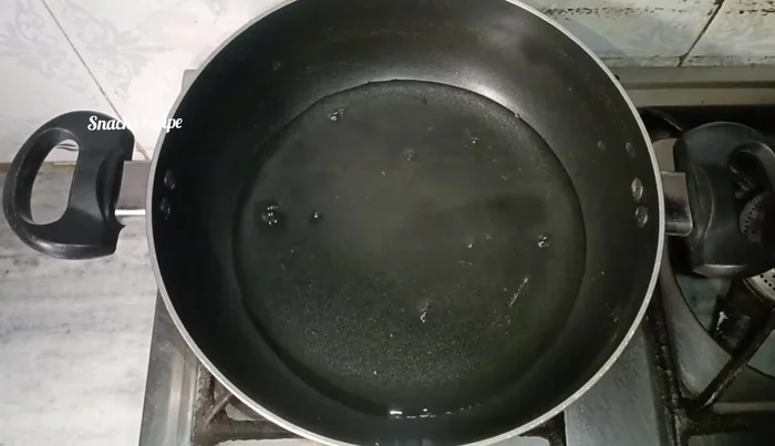 In a pan, boil 1 cup of water with 1/4 teaspoon salt, 1 tablespoon oil, 1/2 teaspoon chili flakes, and chopped coriander leaves.