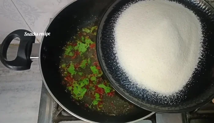Add 3/4 cup semolina to the boiling water and mix quickly to prevent lumps from forming.