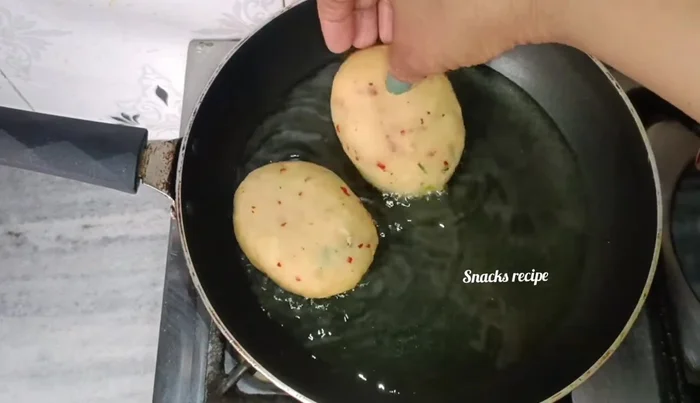 Heat oil in a pan for shallow frying. Fry the snacks until golden brown and crispy, flipping halfway through.