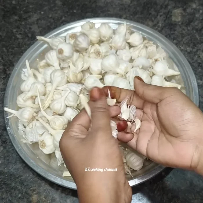 Separate garlic cloves using one of three methods: 1) Manually separate cloves; 2) Gently hit the garlic bulb with a heavy object; 3) Use a garlic press.
