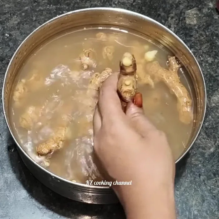 After soaking, mash ginger and remove the outer skin using a knife.