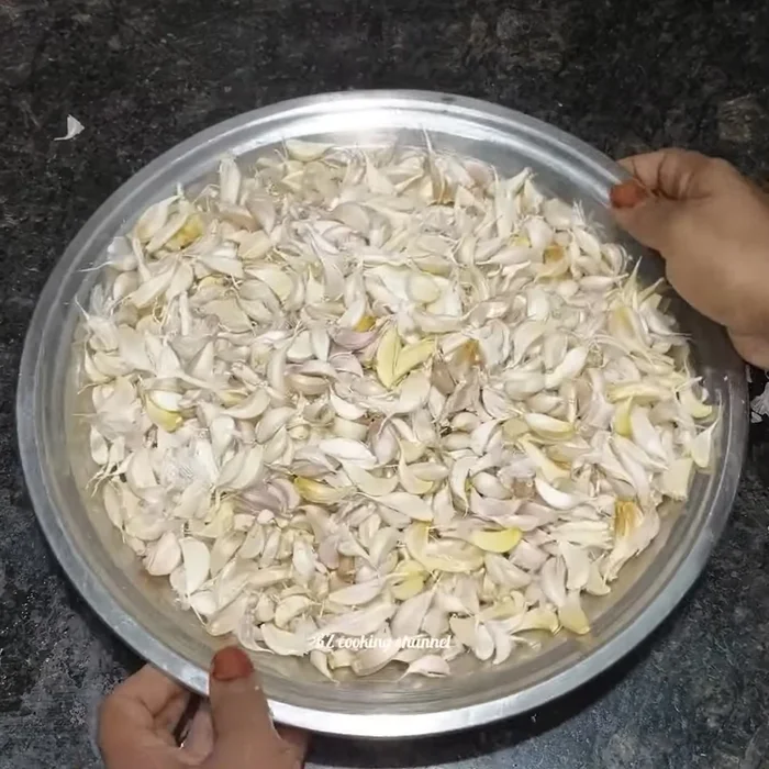 Massage the separated cloves gently with your hands to loosen the peel. Crush them slightly to remove any remaining bits of peel.