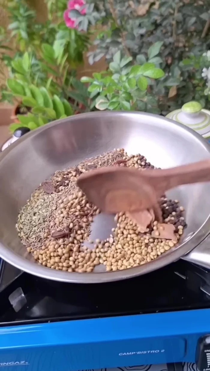 Remove the roasted spices from the pan and place them in a separate bowl.