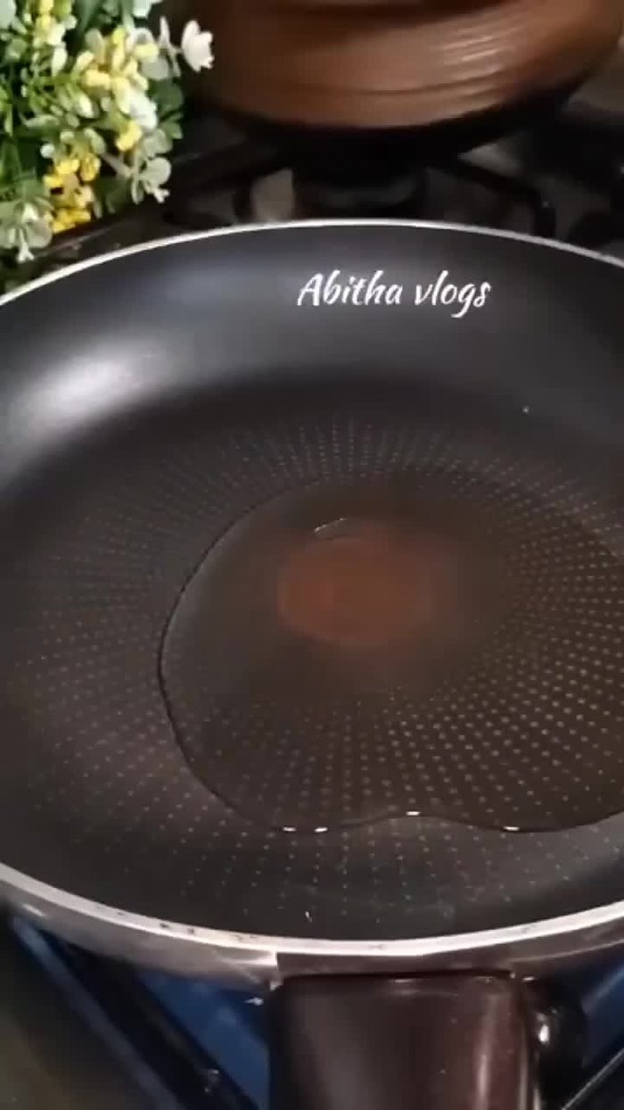 Heat the pan and pour in coconut oil. Cut the unripe plantain into two and fry it.