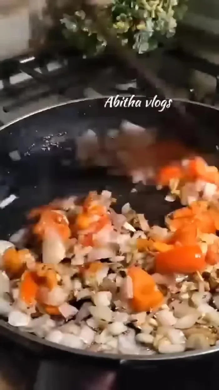Add the chopped onions and tomato. Add salt, Kashmiri chili, coriander powder, turmeric powder, and kayam powder.
